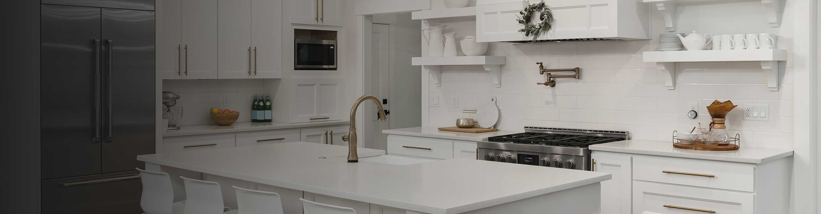 Kitchen with marble flooring and white cabinetry
